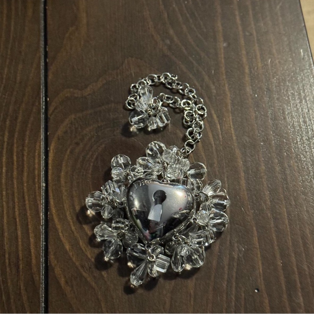Christian Dior silver heart shaped compact on a keychain